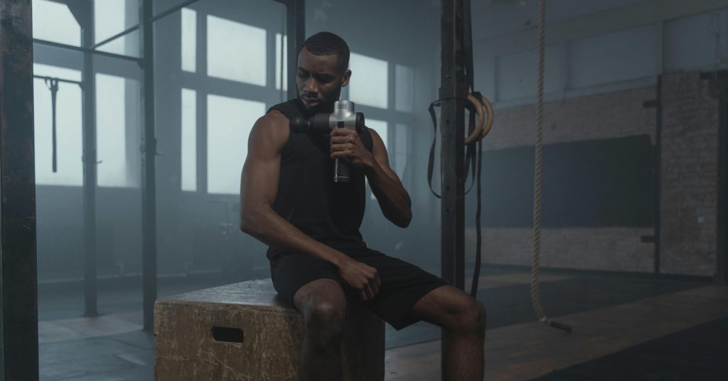 Fit man sitting on wooden box