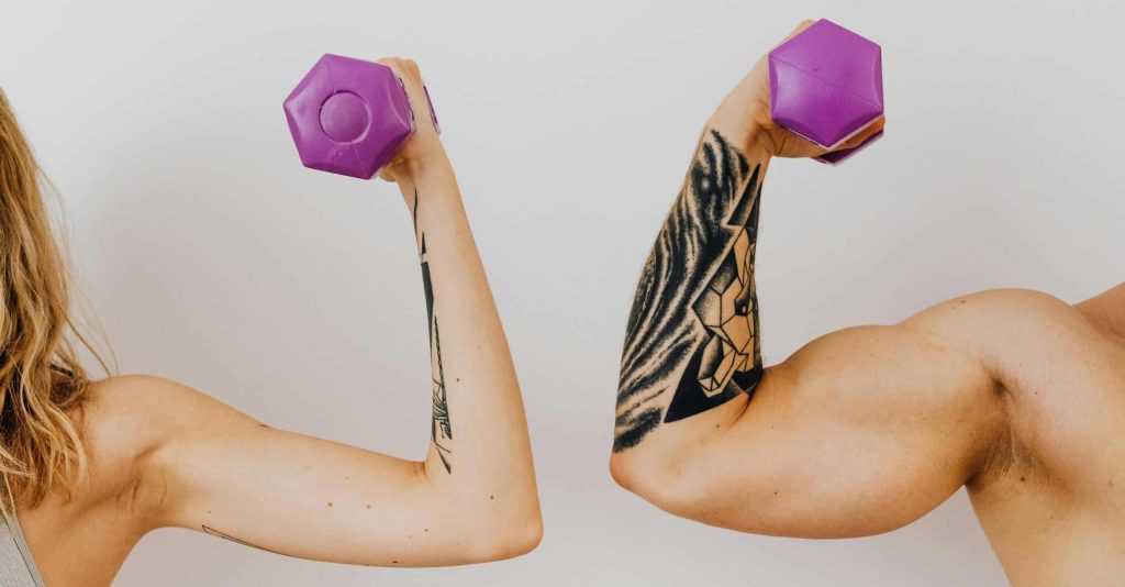 Men and woman flexing biceps